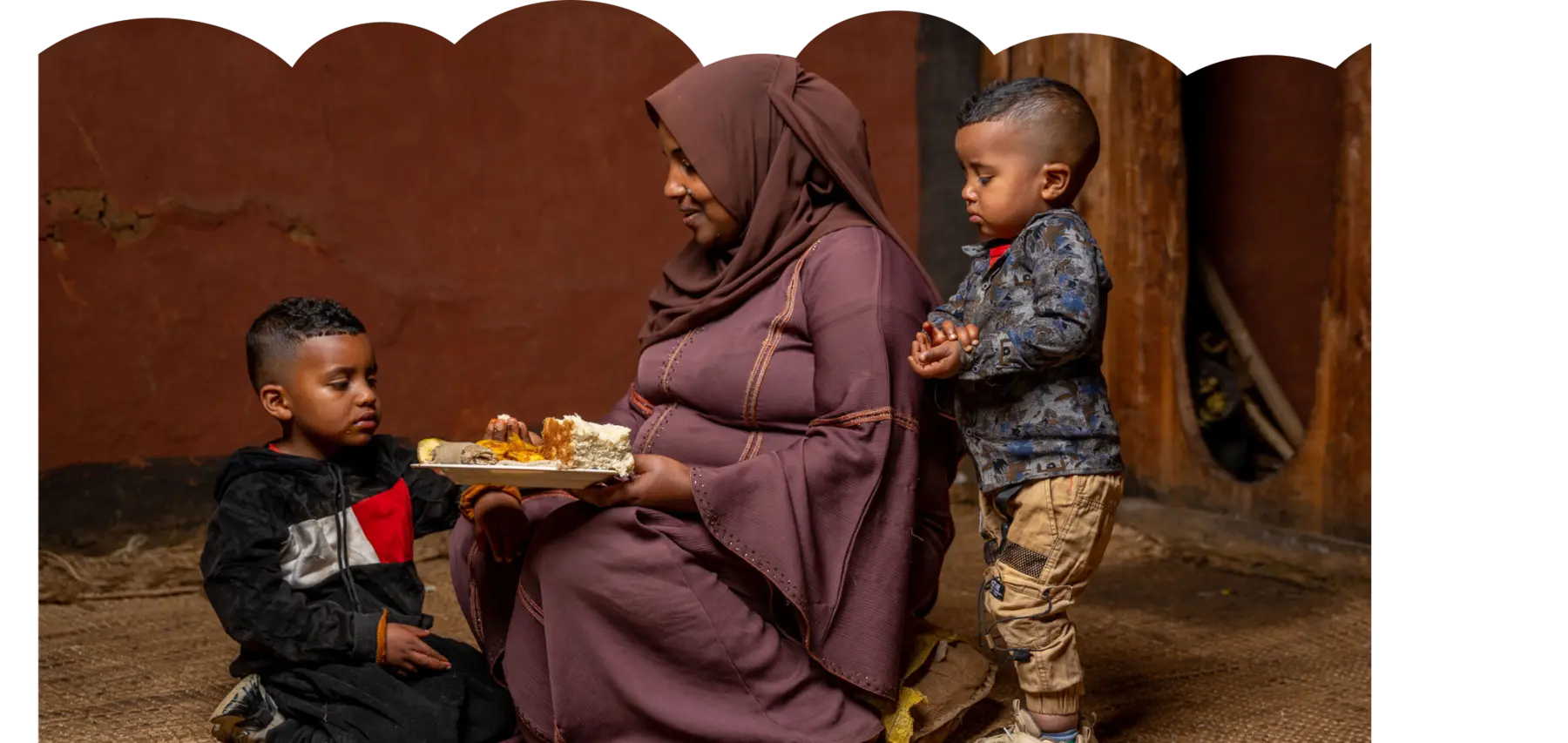 A mother shares a meal with her children