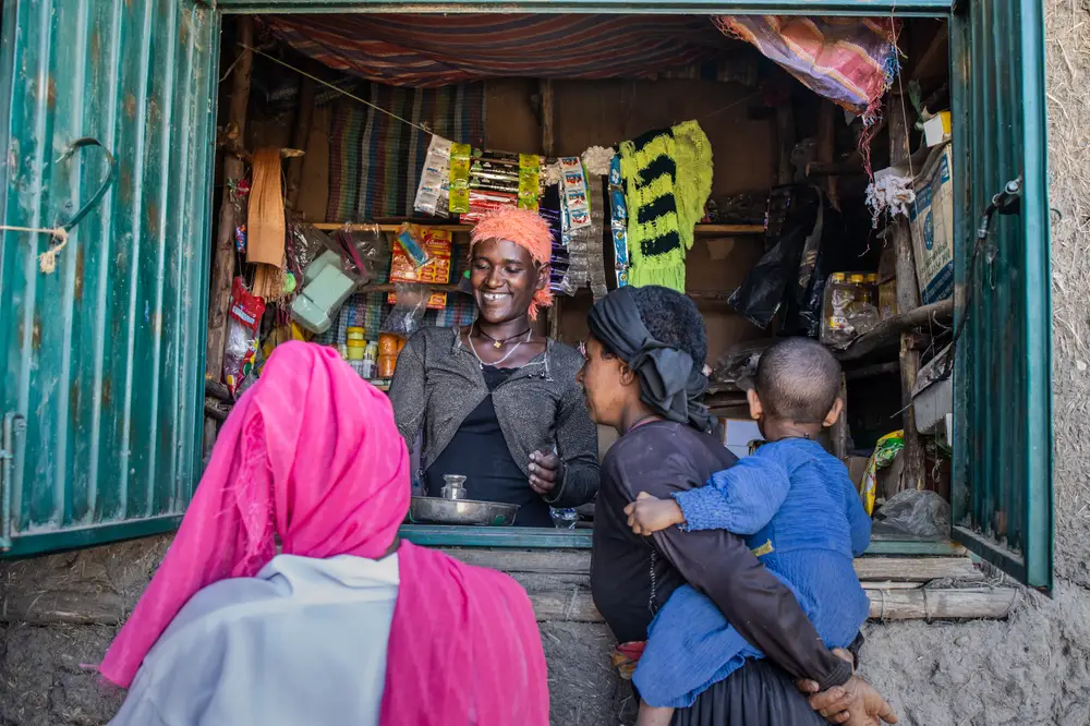 Muluwork Tesfaw serving customers at her shop in Mergech kebele